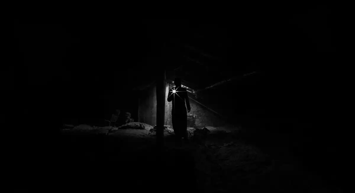 Hombre en la oscuridad con una linterna