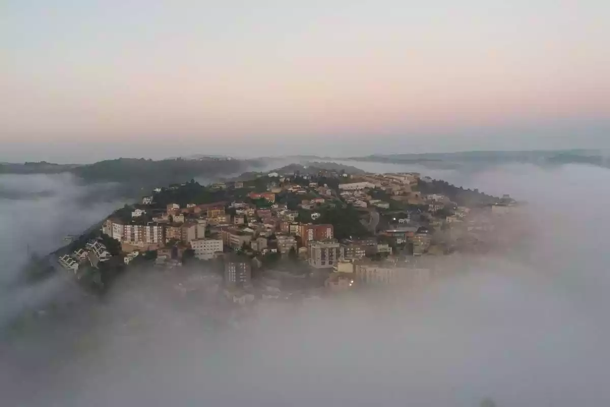 Imagen de una población con un poco de niebla