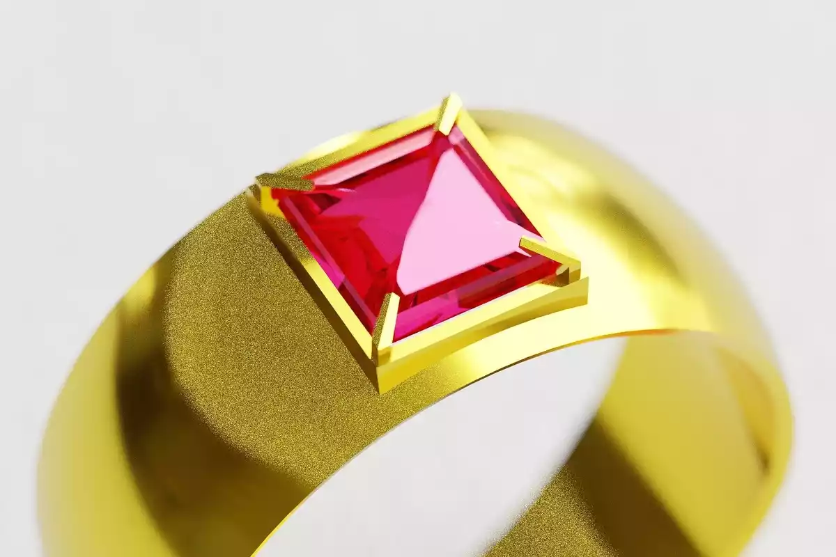 Un anillo de oro con un gran rubí rojo