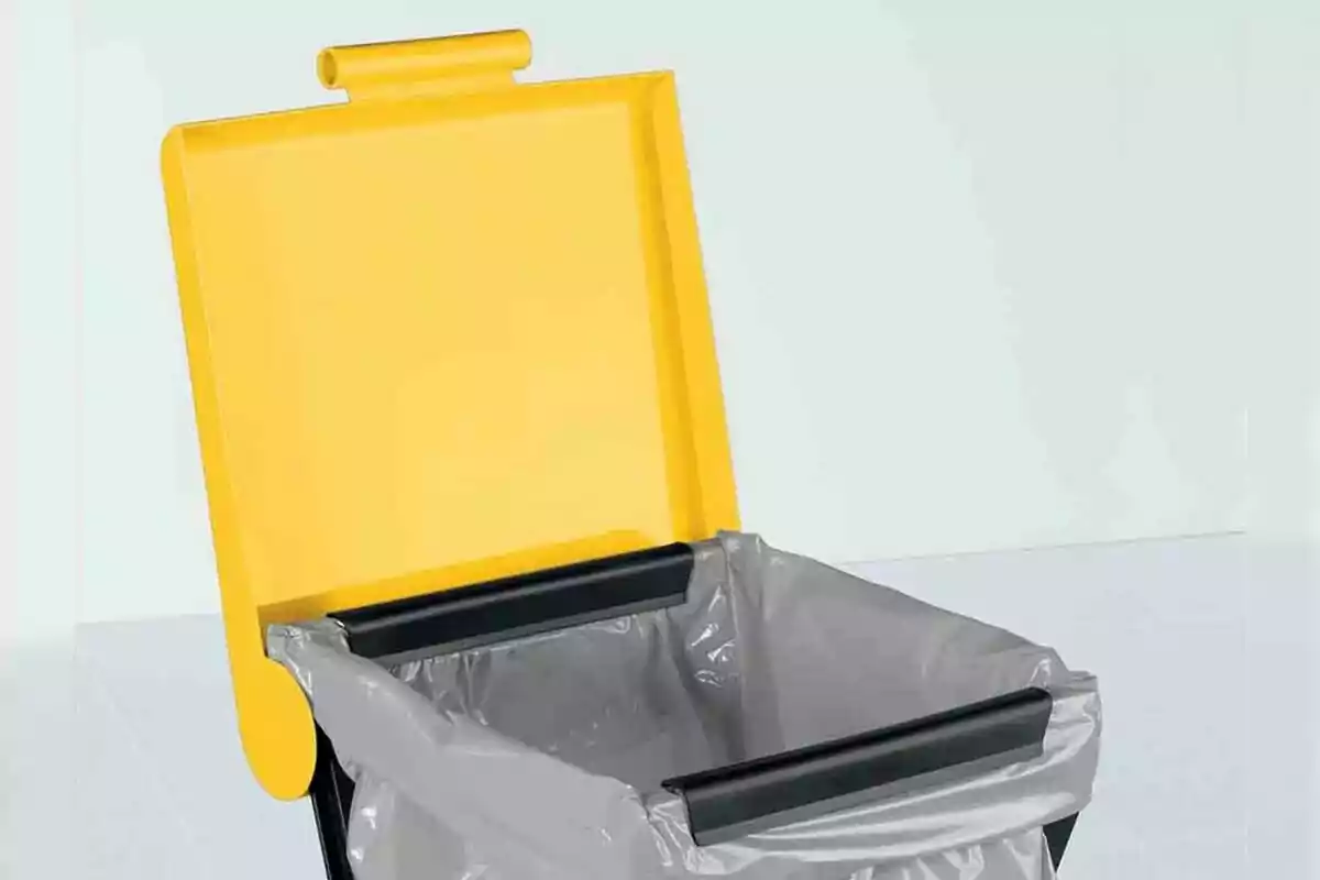 A Lidl trash can with an open yellow lid and a gray bag inside. A Lidl trash can with an open yellow lid and a gray bag inside.